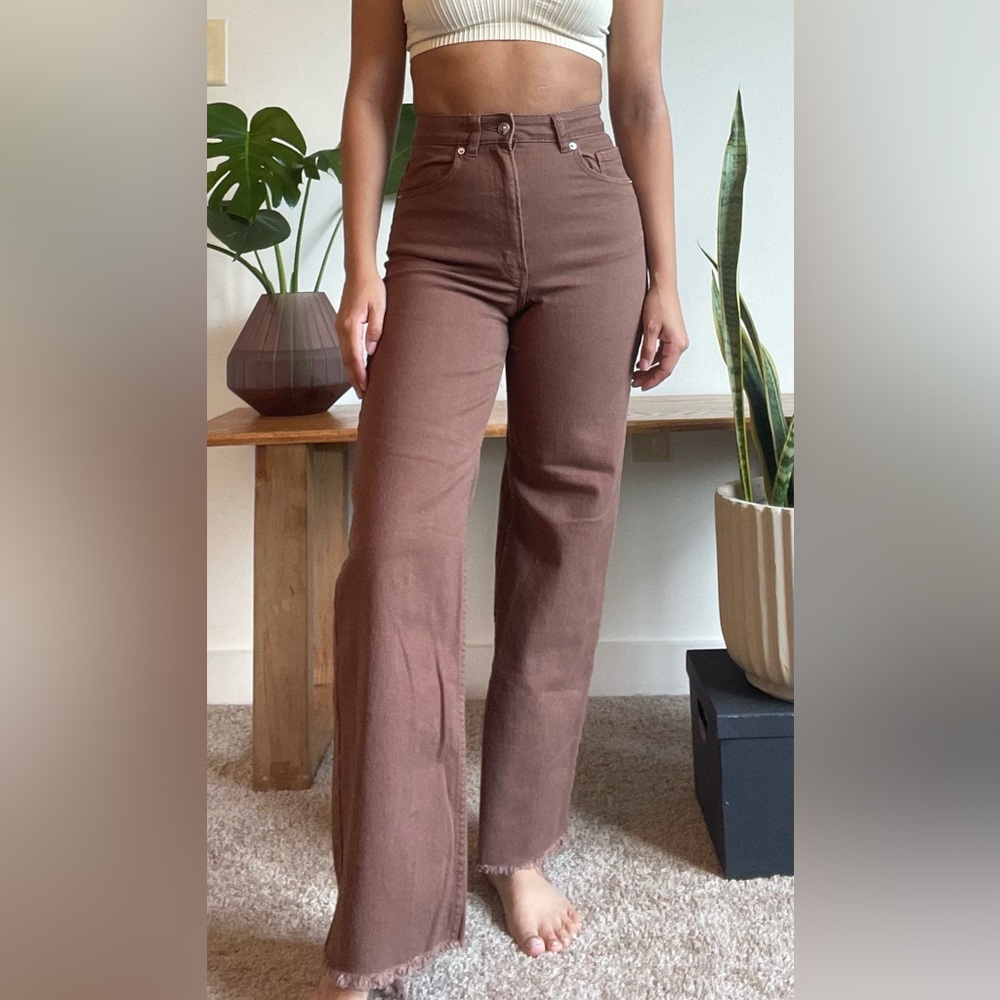 Brown pants with wider leg and frayed cut. Model is 5’0”- 110lbs for reference.